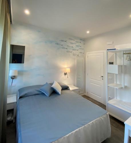 a bedroom with a large blue bed with blue pillows at Villa D Erna Marina di Pietrasanta in Marina di Pietrasanta