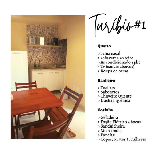 a picture of a kitchen with a table and a chart at Apartamento no Centro Búzios in Búzios