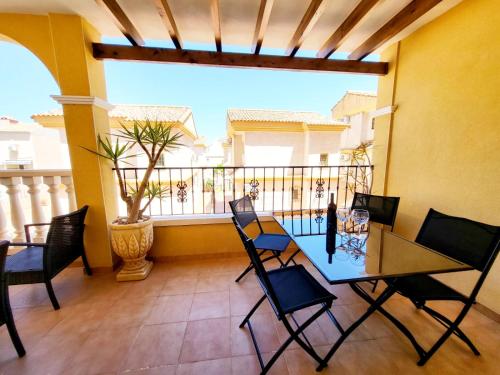 a dining room with a table and chairs on a balcony at Apartment Fontana Golf Villamartin in Orihuela Costa