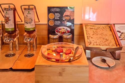 a table with two bottles of wine and a casserole at Eco Hotel Ariston in Malcesine