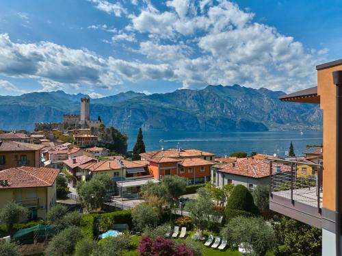 a town with a view of the water and mountains at Eco Hotel Ariston in Malcesine