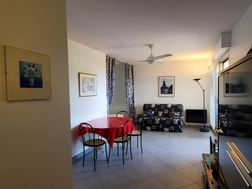 - un salon avec une table et des chaises rouges dans l'établissement Saint-RAPHAEL La Peguiere Face a la plage Vue Mer, à Saint-Raphaël
