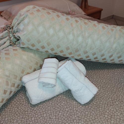 a pair of rolled up towels on a bed at Corte Lavito in Tuglie