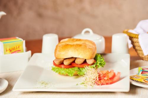 a sandwich on a plate on a table at Hotel Los Tambos Boutique in Arequipa