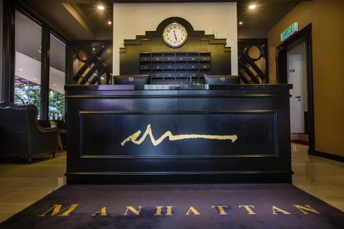 a bar with a sign that reads amsterdam with a clock at Manhattan Business Hotel Damansara Perdana in Petaling Jaya
