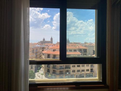 a view of a city from a window at Hotel Condal in Salamanca