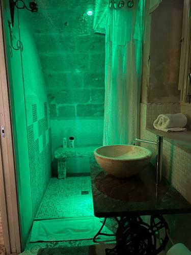 a bathroom with a sink and a shower with a bowl at Palazzo Savoia 1856 in Fasano