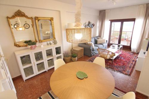 a living room with a table and a mirror at Piso con vistas a la playa de Laredo - APARTAMENTO BELLAVISTA in Laredo