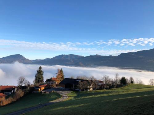 a house on a hill with fog in the mountains at Kailgut in Hallein