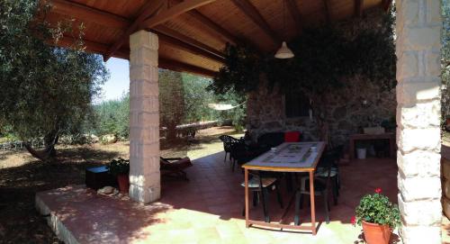 un patio avec une table sous un toit en bois dans l'établissement Casa Giuliva, à Ferla