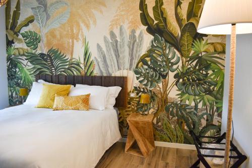 a bedroom with a wall mural of plants at Bed and Breakfast Le Giale in Castelnuovo del Garda
