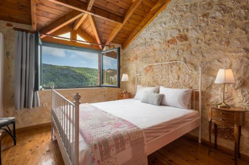 a bedroom with a bed and a large window at Zakynthos Shipwreck Nearby&Easy Parking&Barbecue Patio in Koiliomenos