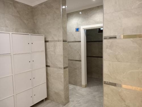 a bathroom with white cabinets and a walk in shower at 2-Room Accommodation in a Luxury Resort in Alanya