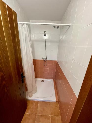 a bathroom with a shower with a toilet in it at Albergue de griegos in Griegos