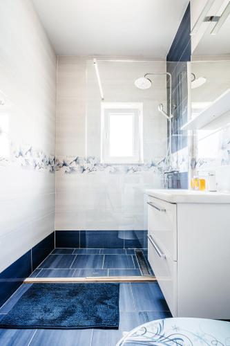 a bathroom with a shower and a sink at Green Hill Apartment in Komaji