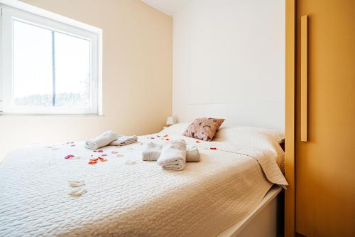 a bedroom with a bed with towels on it at Green Hill Apartment in Komaji