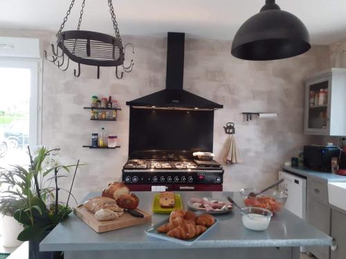 a kitchen with a stove with a bunch of bread at La Petite Salamandre in Chitenay