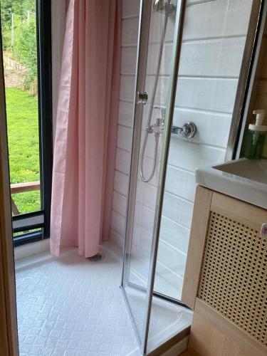 a bathroom with a shower and a sink at Vagona Tiny House in Rize