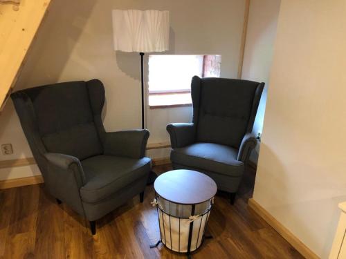 two chairs and a table in a living room at Selská chalupa Anetka in Horšovský Týn
