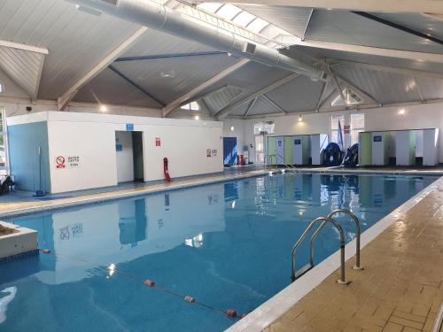 a large swimming pool with blue water at 6 Little Cherubs Holiday Home in Cowes