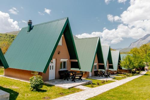 a row of modular homes with green roofs at Bungalow Holiday in Pluzine