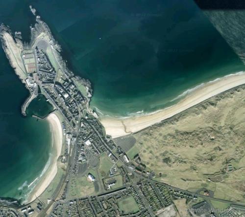 an aerial view of a beach and the ocean at Portrush by the Sea - 6 Golf Terrace in Portrush