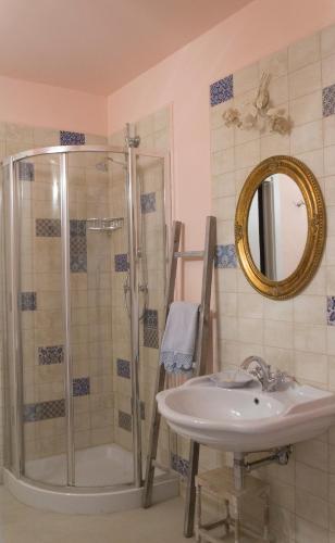 a bathroom with a shower and a sink and a mirror at Residenza dei Piaceri Perduti-Rosa in Lastra a Signa