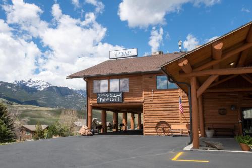 a log cabin building with a sign on it at The Antler Lodge - Gardiner in Gardiner