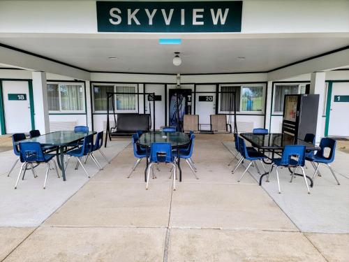 a group of tables and chairs in a building at Skyview Motel - Prairie du Sac in Prairie du Sac
