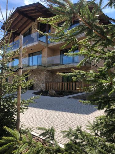 a building with trees in front of it at Björg Apartment & Sauna in Donovaly
