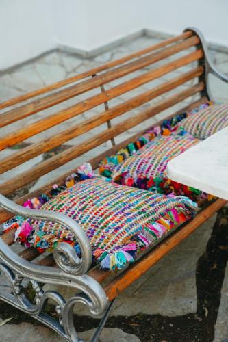 a bench with a colorful blanket on it at Βίλλα Φανούλα Villa Fanoula in Chorto