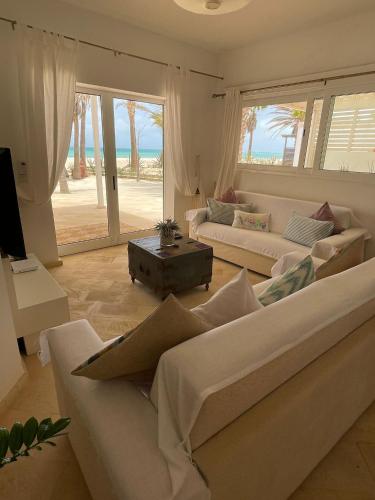 a living room with two couches and a view of the ocean at Villa Nº 25 Alfredo Marchetti Suites on the Beach,Praia de Chaves BV in Cabeçadas