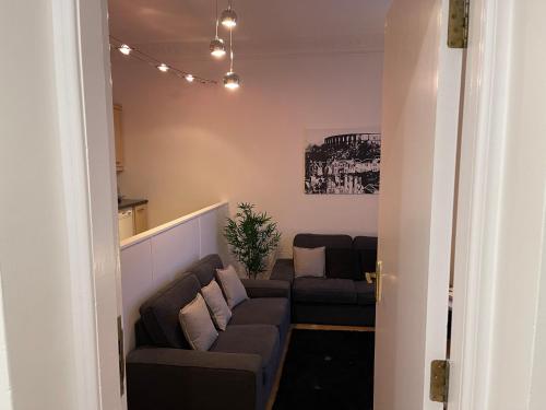 a living room with a couch and two couches at Heart of George Street 2 in Oban