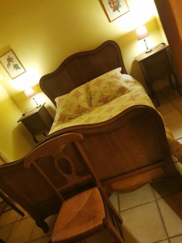 a bed in a room with two night stands and two lamps at Mes Maisons Gardoises, Two Gites sleeping 13 with Two Private pools, Kids Room, Laundry, Disco, free WiFi, Linen and Dog's are Welcome in Gagnières