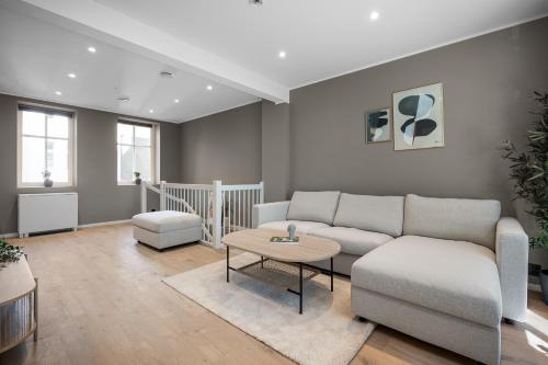 a living room with a couch and a table at Stay Nygård - Serviced apartments in central Bergen in Bergen