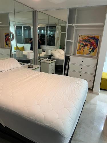 a bedroom with a bed and a large mirror at Yoa’s escape in San Juan