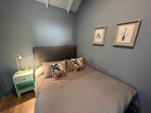 a bedroom with a bed with two pillows and a night stand at Hotel Florencia in Viña del Mar