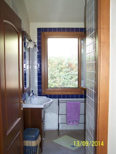 a bathroom with a sink and a window at Villa Julia in Tertenìa