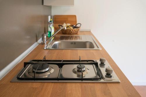 a kitchen counter with a stove and a sink at ALOE - Villa Luisa: Pace e Relax a 2 passi dal mare in Casarza Ligure