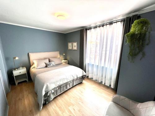 a bedroom with a bed and a large window at Hotel Florencia in Viña del Mar