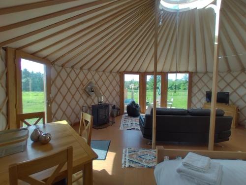 a living room with a couch in a yurt at Embrace the Space in Cwm-Morgan