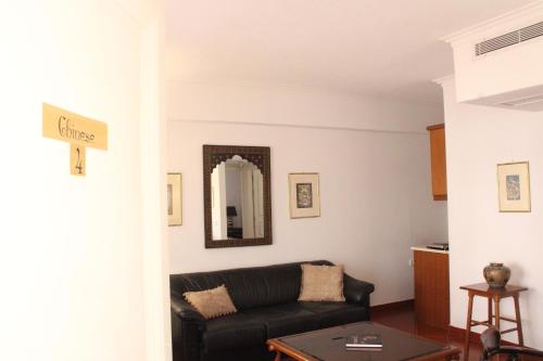 a living room with a couch and a mirror at Candia House in Kandia