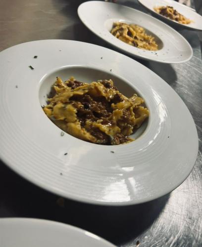 a bowl of food on a white plate on a table at LOCANDA PODERE LE VIGNE in Radda in Chianti