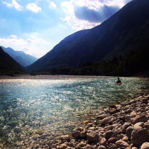 a person is kayaking on a river in the mountains at Apartma Bovec Center in Bovec