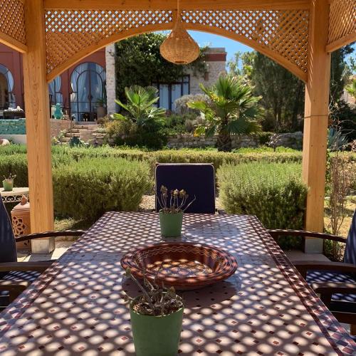 a table with a bowl on it on a patio at Villa des Hauts Mogador in Essaouira