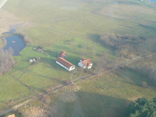 an aerial view of a farm with a house at Stawy Karłowo in Karłowo