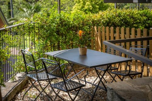 a table with two chairs and a potted plant on it at MIMOSA - Villa Luisa: Pace, Relax a 2 passi dal mare in Casarza Ligure