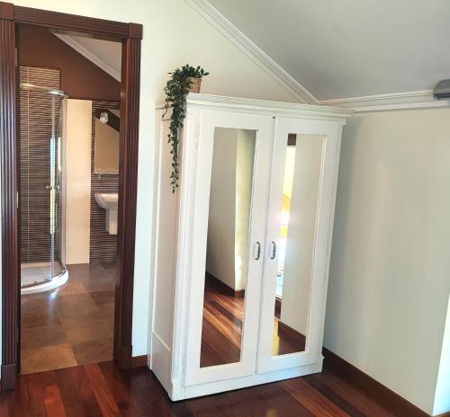 a room with a door with a mirror at Casa Baixo O Castelo in Puente Caldelas