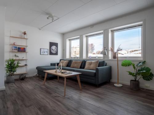 a living room with a couch and a table at Cozy apartment by the sea in Tromsø
