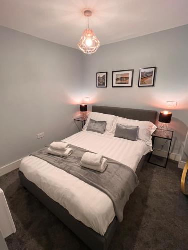a bedroom with a large bed with two towels on it at Severn Valley Guest House in Bewdley